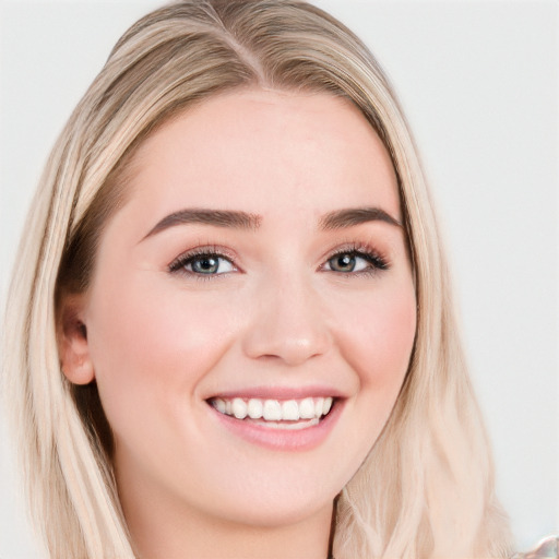 Joyful white young-adult female with long  brown hair and blue eyes