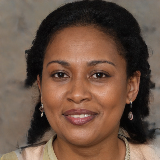 Joyful black adult female with medium  black hair and brown eyes