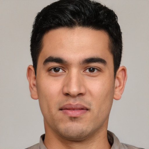 Joyful white young-adult male with short  black hair and brown eyes