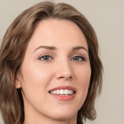 Joyful white young-adult female with medium  brown hair and green eyes