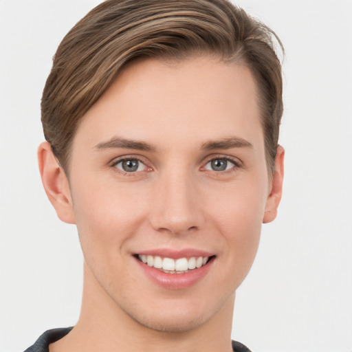 Joyful white young-adult female with short  brown hair and grey eyes