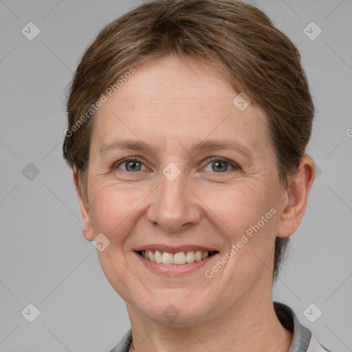 Joyful white adult female with short  brown hair and grey eyes