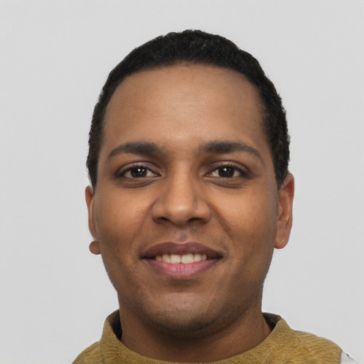 Joyful black young-adult male with short  black hair and brown eyes