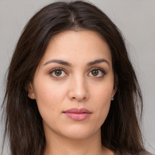 Joyful white young-adult female with long  brown hair and brown eyes