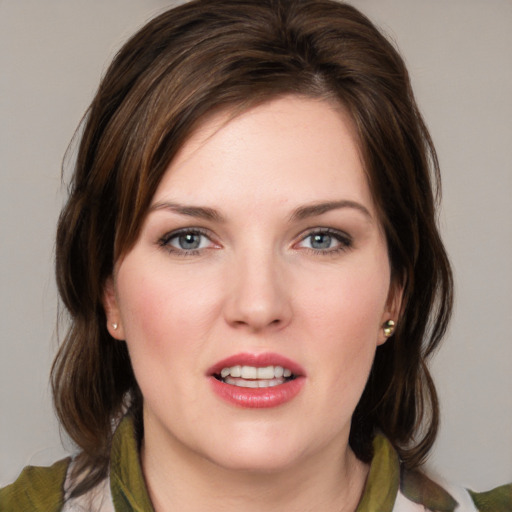 Joyful white young-adult female with medium  brown hair and green eyes