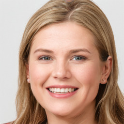 Joyful white young-adult female with long  brown hair and blue eyes