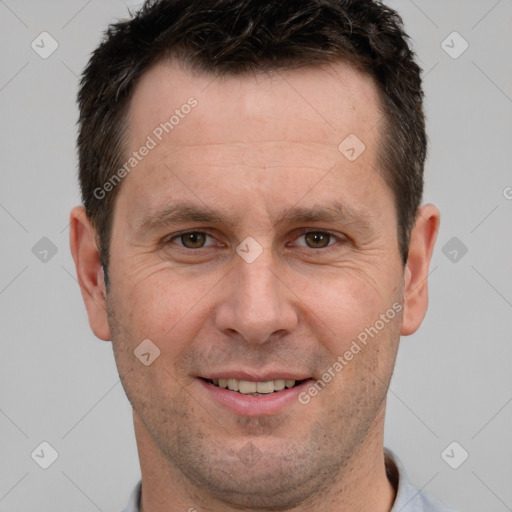 Joyful white adult male with short  brown hair and brown eyes