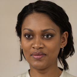 Joyful black adult female with medium  brown hair and brown eyes