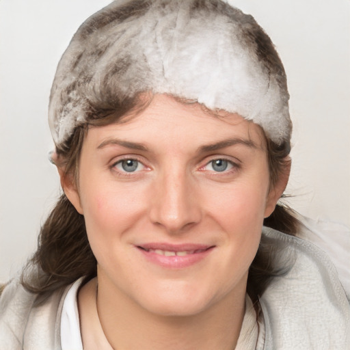 Joyful white young-adult female with medium  brown hair and grey eyes