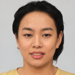 Joyful asian young-adult female with short  black hair and brown eyes