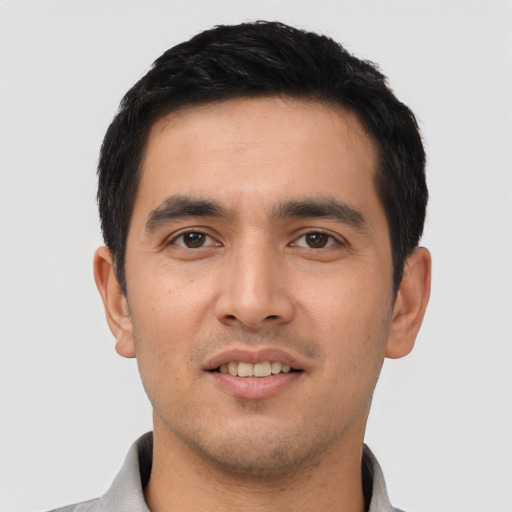 Joyful asian young-adult male with short  black hair and brown eyes
