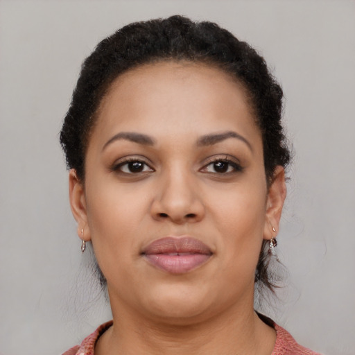 Joyful black young-adult female with short  brown hair and brown eyes