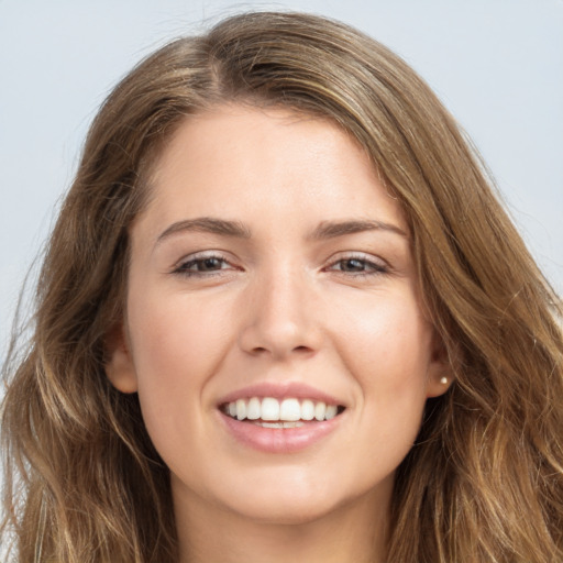 Joyful white young-adult female with long  brown hair and grey eyes