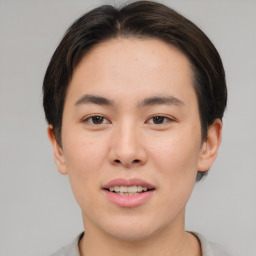 Joyful asian young-adult male with short  brown hair and brown eyes