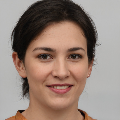 Joyful white young-adult female with medium  brown hair and brown eyes