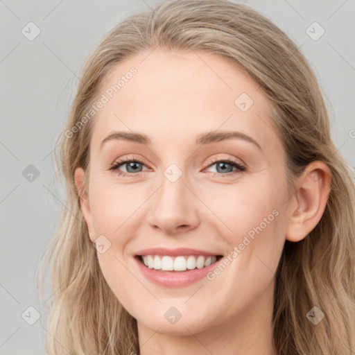 Joyful white young-adult female with long  brown hair and blue eyes