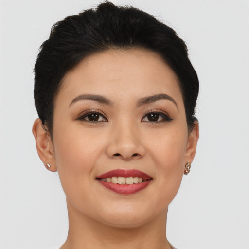Joyful asian young-adult female with short  black hair and brown eyes