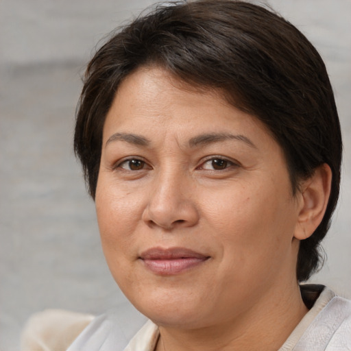 Joyful white adult female with medium  brown hair and brown eyes
