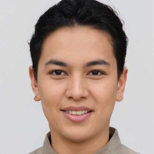 Joyful asian young-adult male with short  brown hair and brown eyes