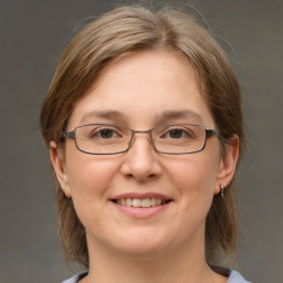 Joyful white adult female with medium  brown hair and grey eyes