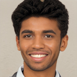 Joyful black young-adult male with short  black hair and brown eyes