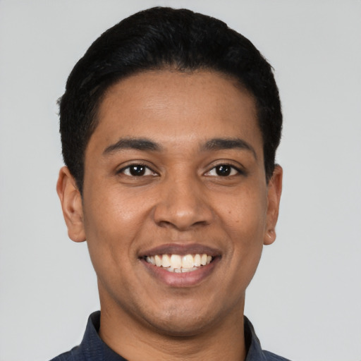 Joyful latino young-adult male with short  black hair and brown eyes