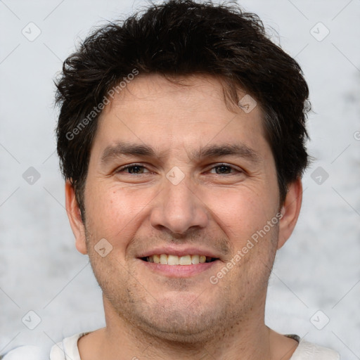 Joyful white adult male with short  brown hair and brown eyes