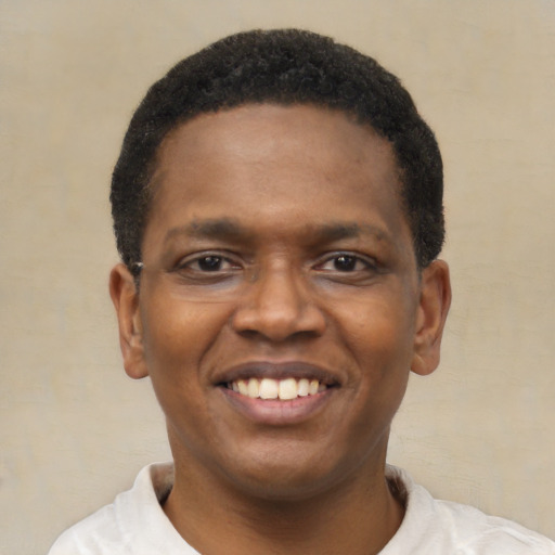 Joyful black young-adult male with short  black hair and brown eyes
