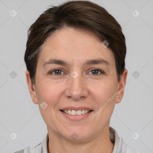 Joyful white adult female with short  brown hair and grey eyes