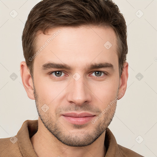 Joyful white young-adult male with short  brown hair and grey eyes