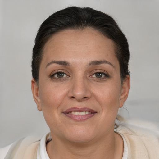 Joyful white adult female with short  brown hair and brown eyes