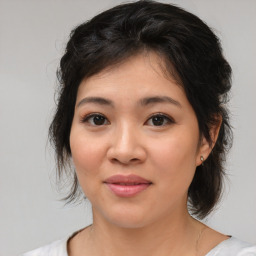 Joyful asian young-adult female with medium  brown hair and brown eyes