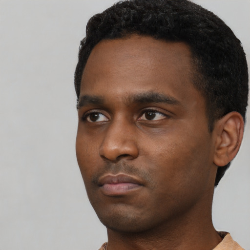 Neutral black young-adult male with short  black hair and brown eyes
