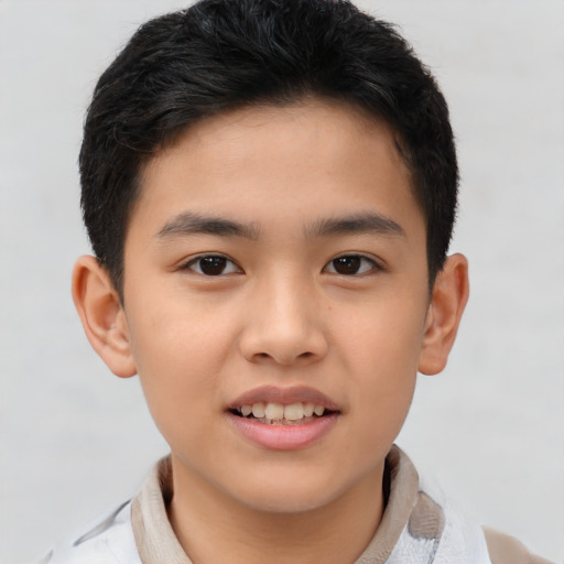 Joyful asian child male with short  brown hair and brown eyes