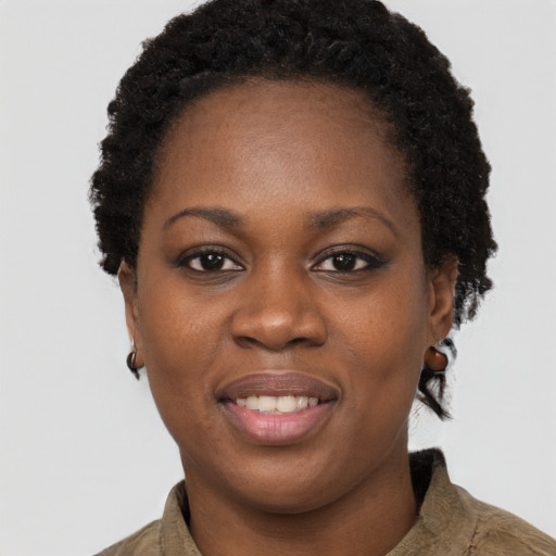 Joyful black young-adult female with short  brown hair and brown eyes
