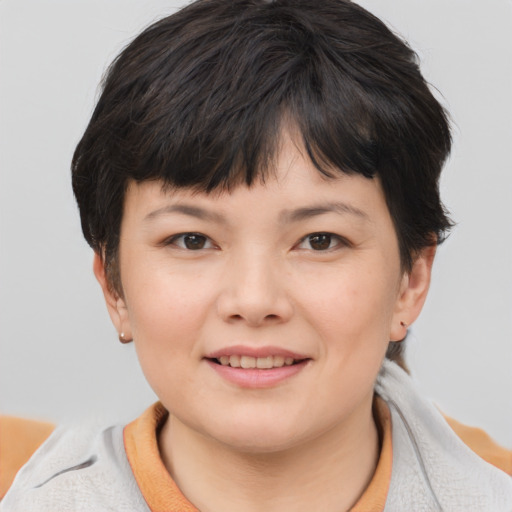 Joyful asian child female with medium  brown hair and brown eyes