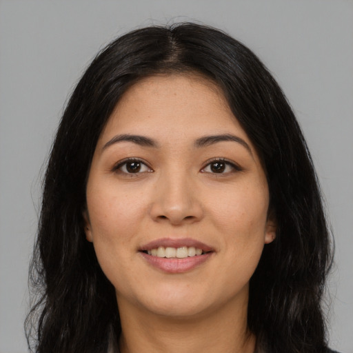 Joyful asian young-adult female with long  black hair and brown eyes