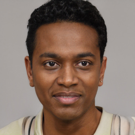 Joyful black young-adult male with short  black hair and brown eyes