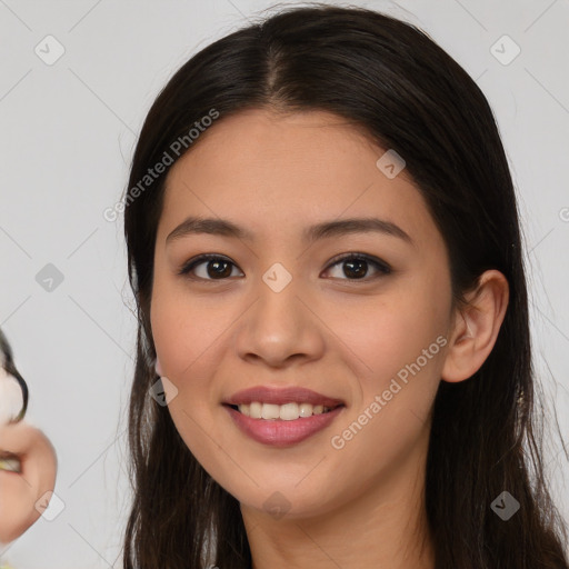 Joyful latino young-adult female with long  brown hair and brown eyes