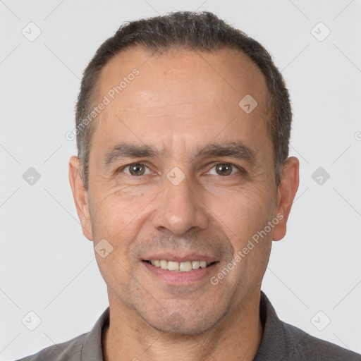 Joyful white adult male with short  brown hair and brown eyes