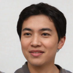 Joyful asian young-adult male with short  black hair and brown eyes