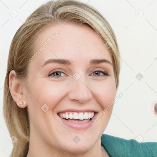 Joyful white young-adult female with long  brown hair and blue eyes