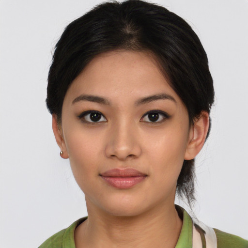 Joyful white young-adult female with medium  black hair and brown eyes