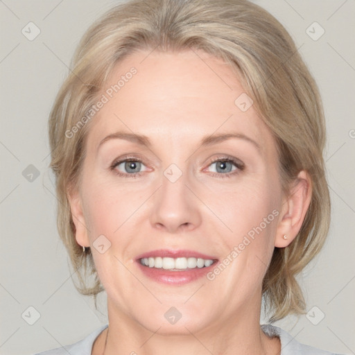 Joyful white adult female with medium  brown hair and blue eyes