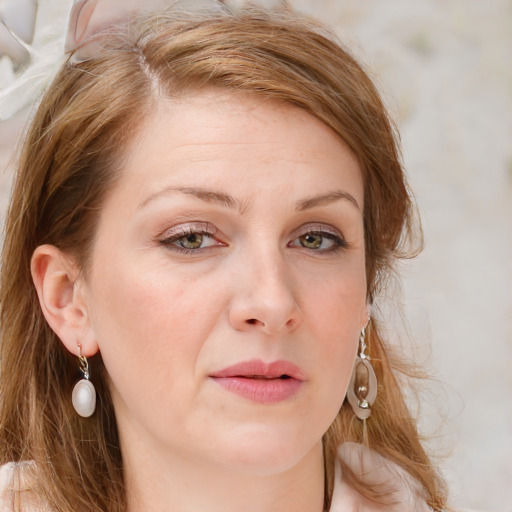 Joyful white young-adult female with long  brown hair and blue eyes