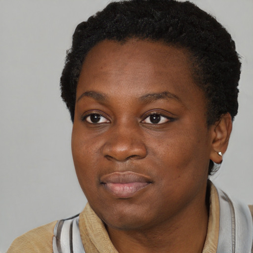 Joyful black young-adult female with short  black hair and brown eyes