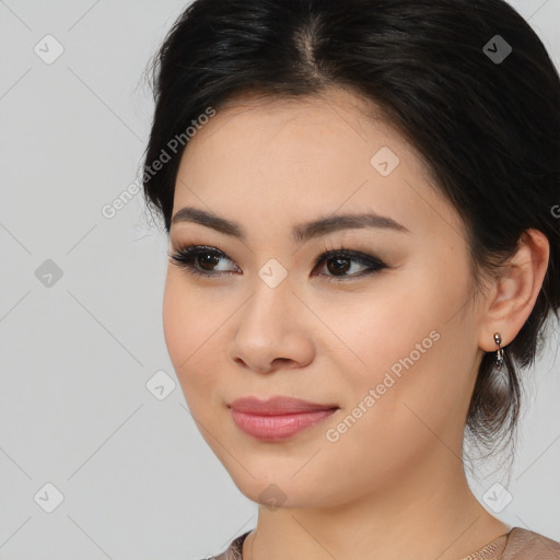 Joyful asian young-adult female with medium  black hair and brown eyes