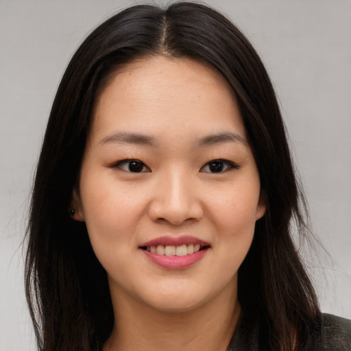 Joyful asian young-adult female with long  brown hair and brown eyes