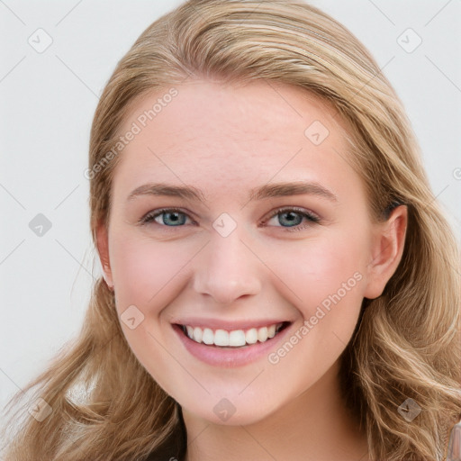 Joyful white young-adult female with long  brown hair and blue eyes