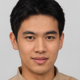 Joyful asian young-adult male with short  brown hair and brown eyes